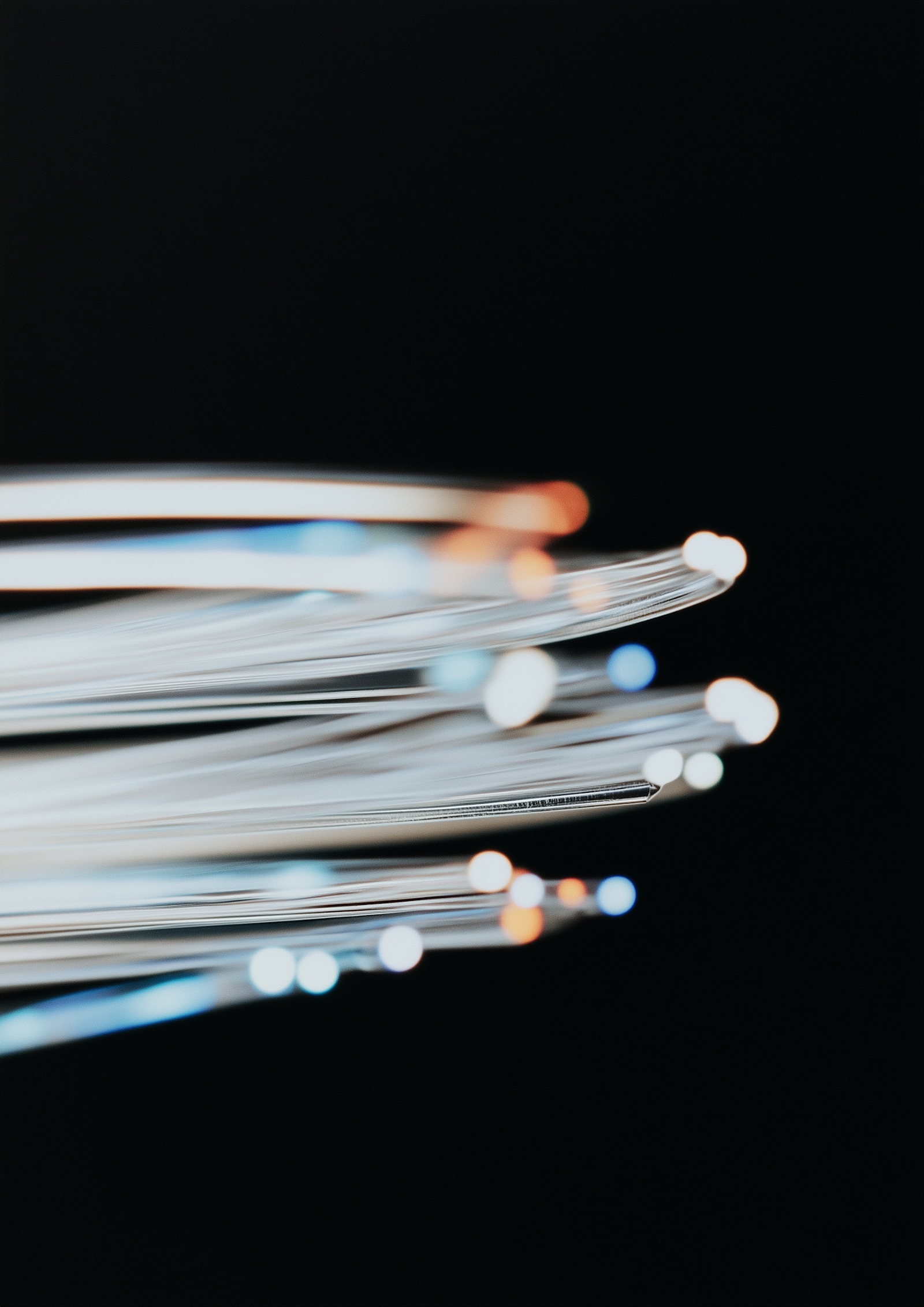 A bundle of fiber optic strands glowing at the tips