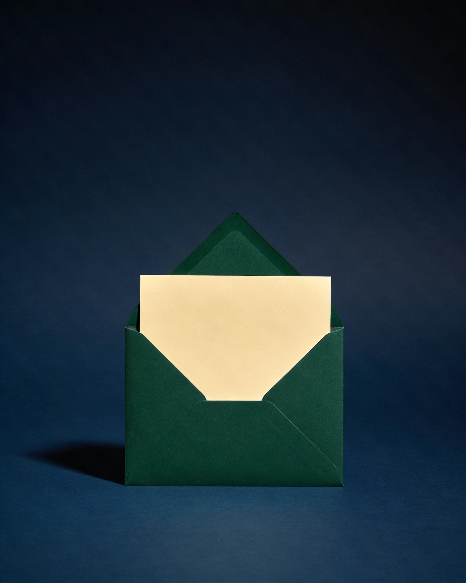 A green envelope holding a letter on a dark blue background