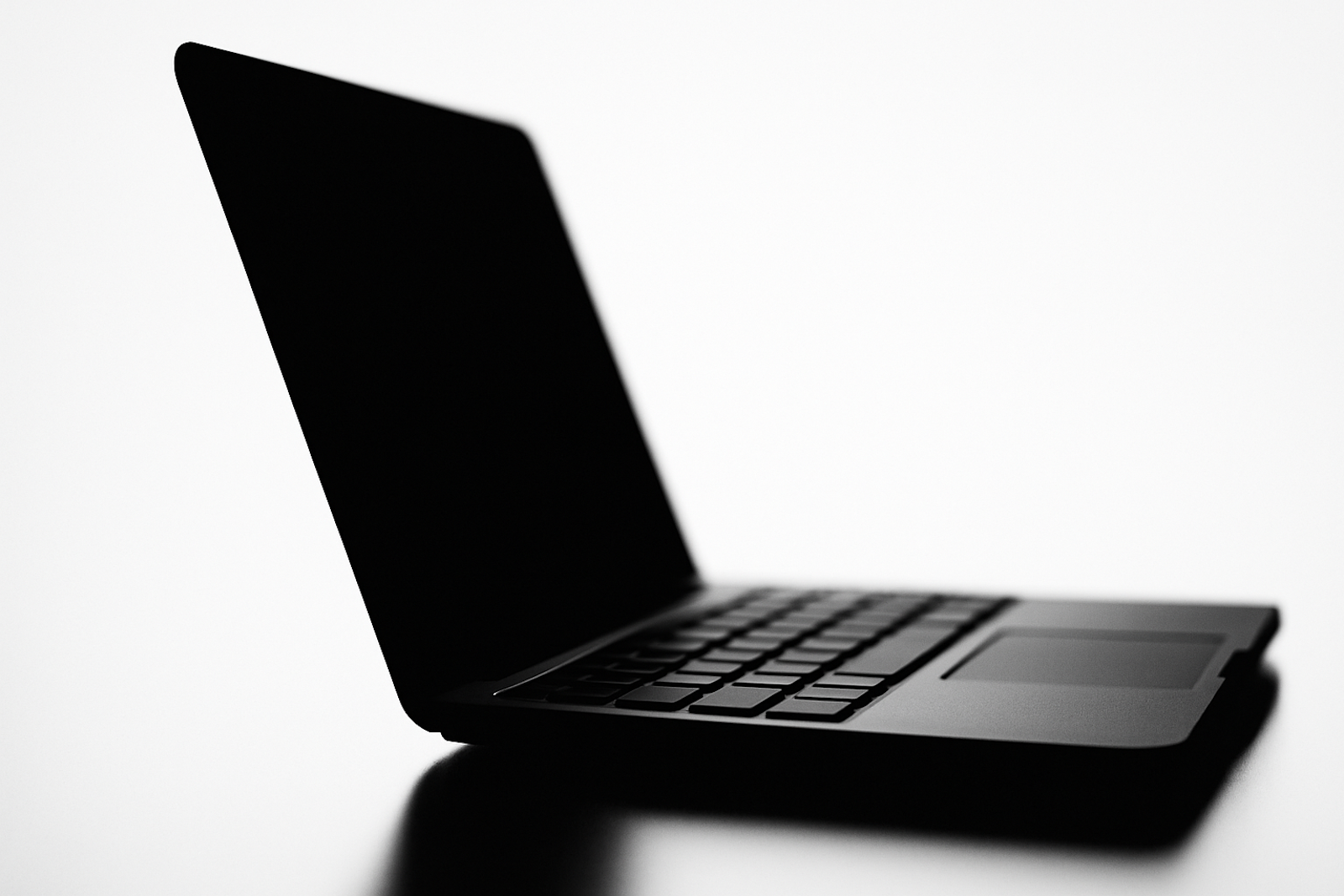 An open laptop silhouetted against a white background