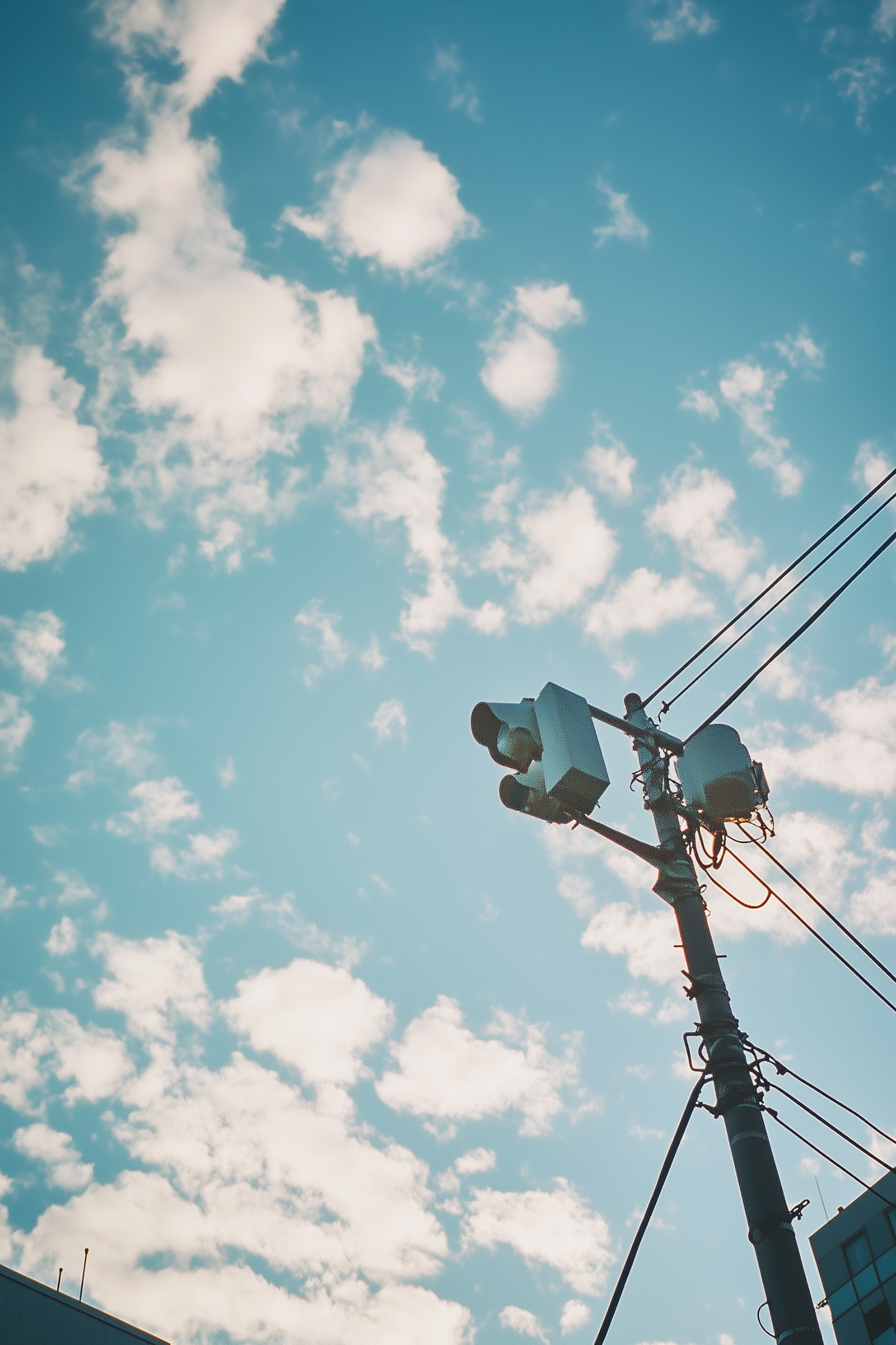 A utility pole with network equipment against a blue sky