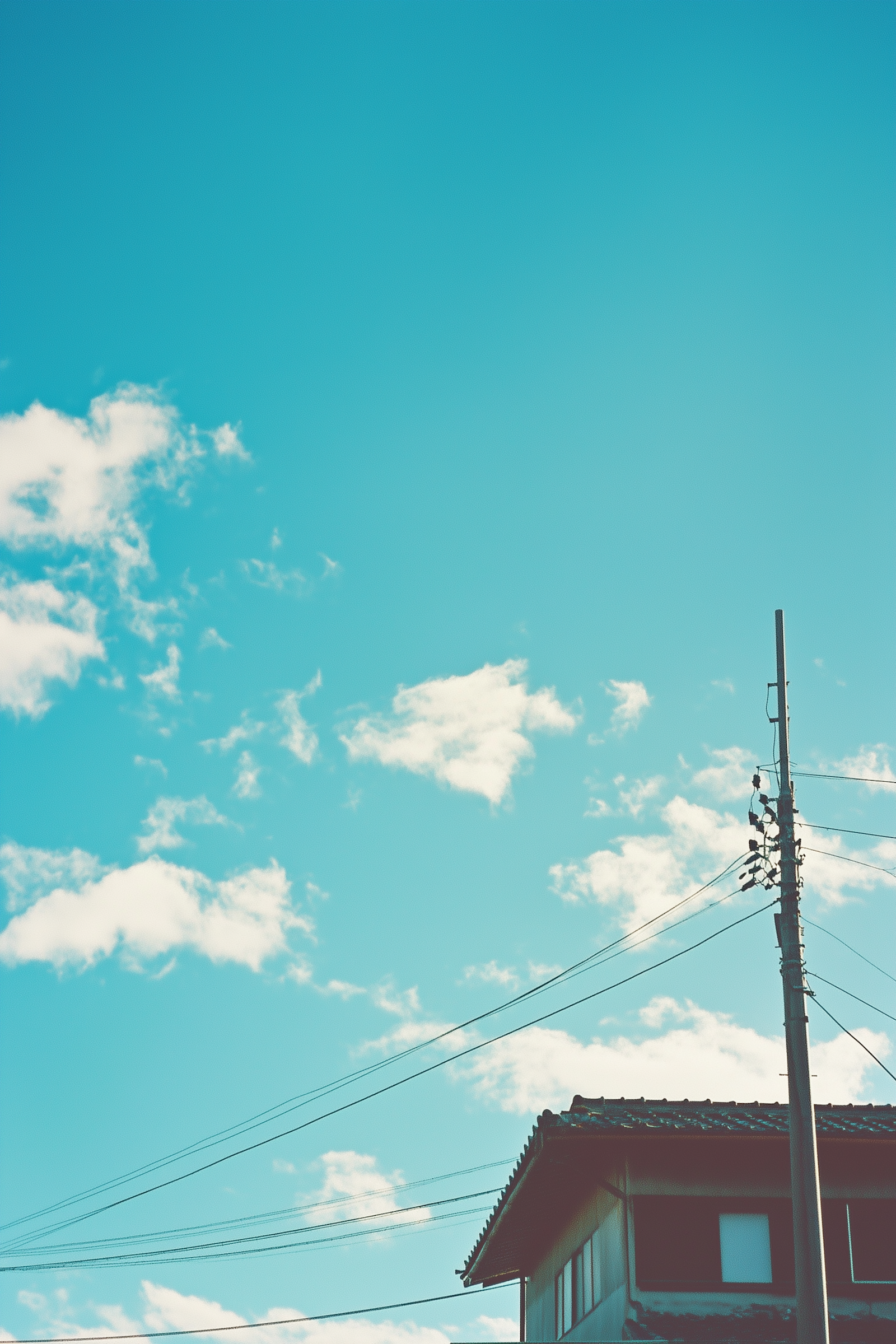 A utility pole and lines against a clear blue sky